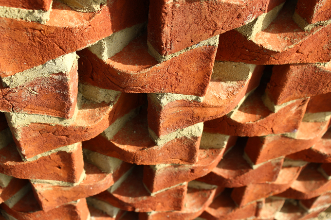 Custom shaped bricks assembled to make a screen wall.