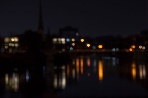 Bokeh photograph of reflections in the river at night